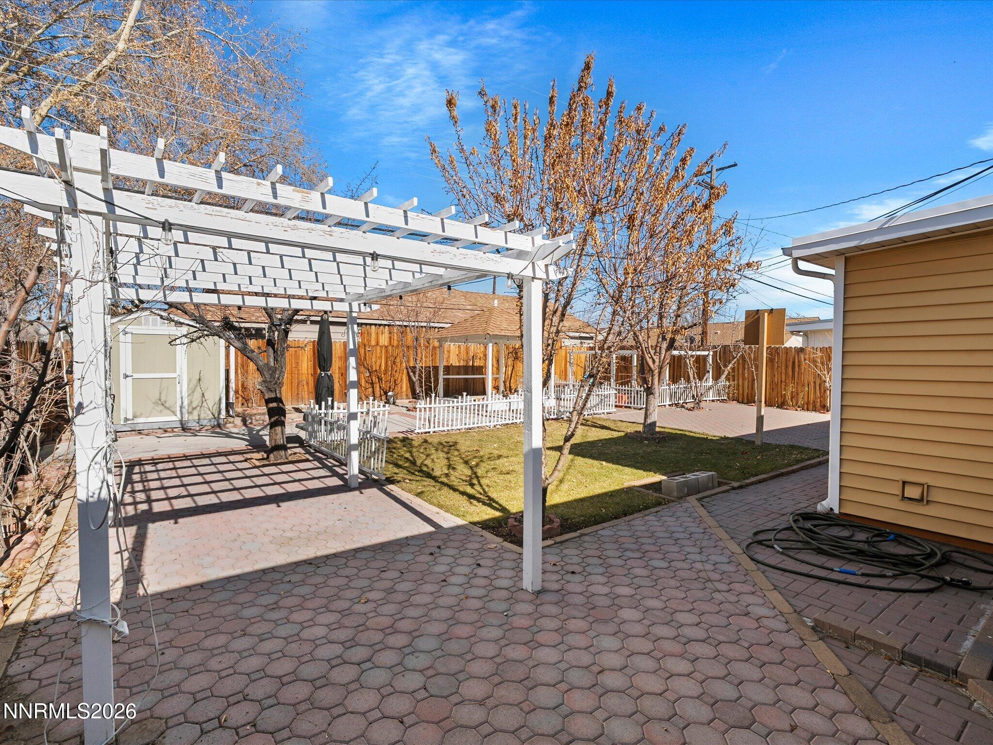 1540 Tyler Way Sparks, NV 89431 - Photo 28 of 35 a view of a patio with table and chairs and wooden fence