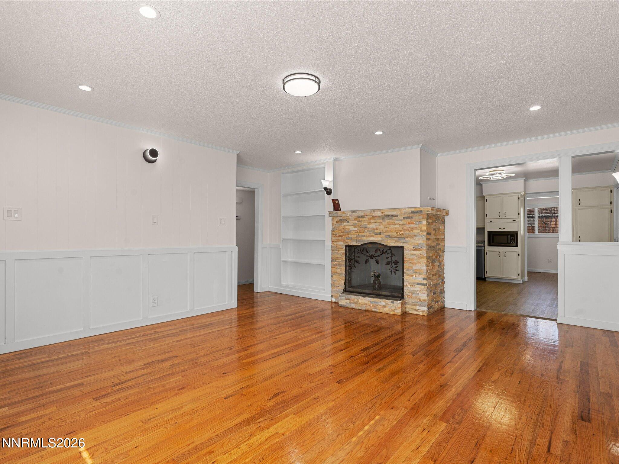 1540 Tyler Way Sparks, NV 89431 - Photo 8 of 35 a view of a livingroom with wooden floor and a fireplace