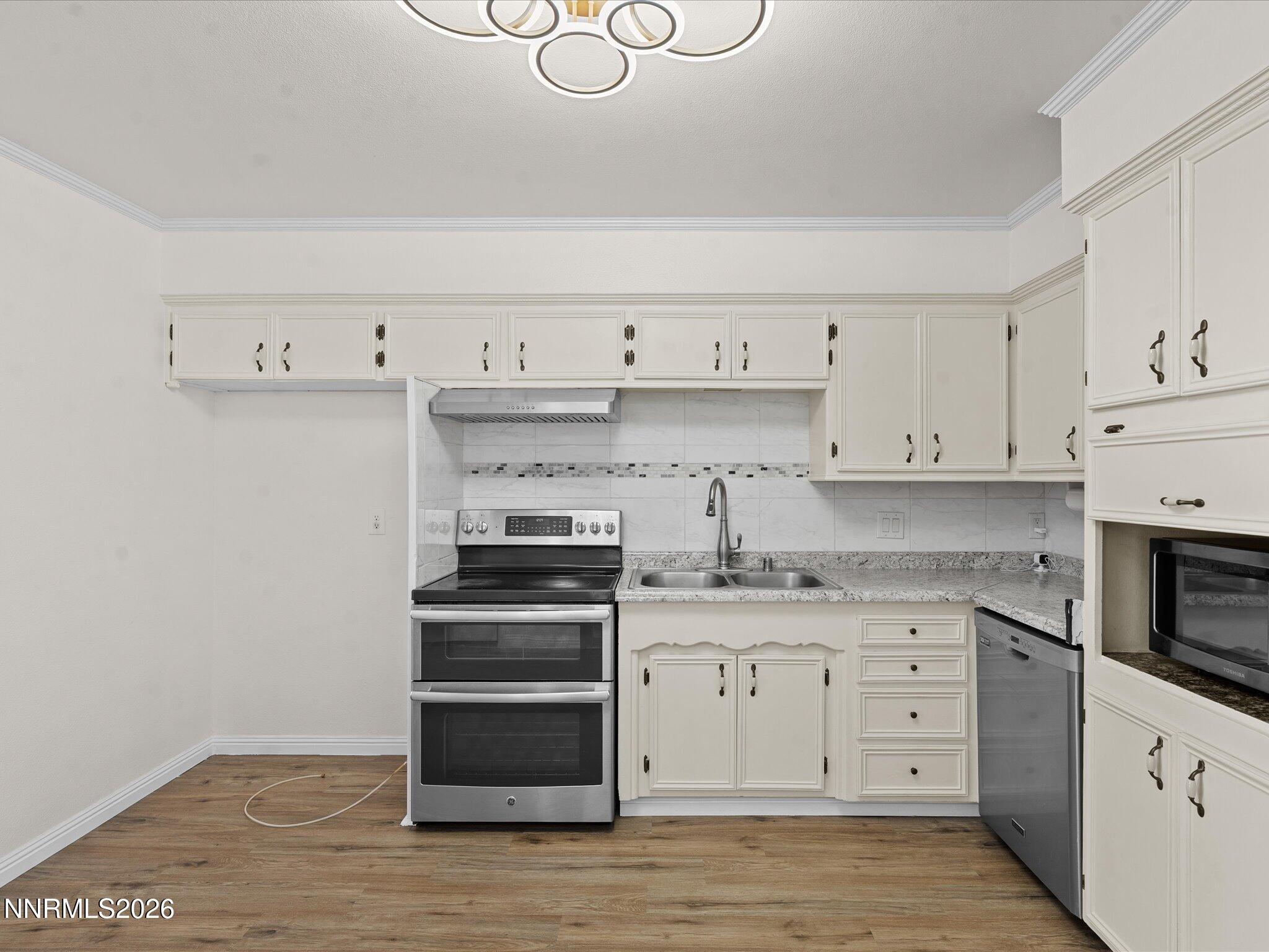 1540 Tyler Way Sparks, NV 89431 - Photo 10 of 35 a kitchen with granite countertop a stove and a sink