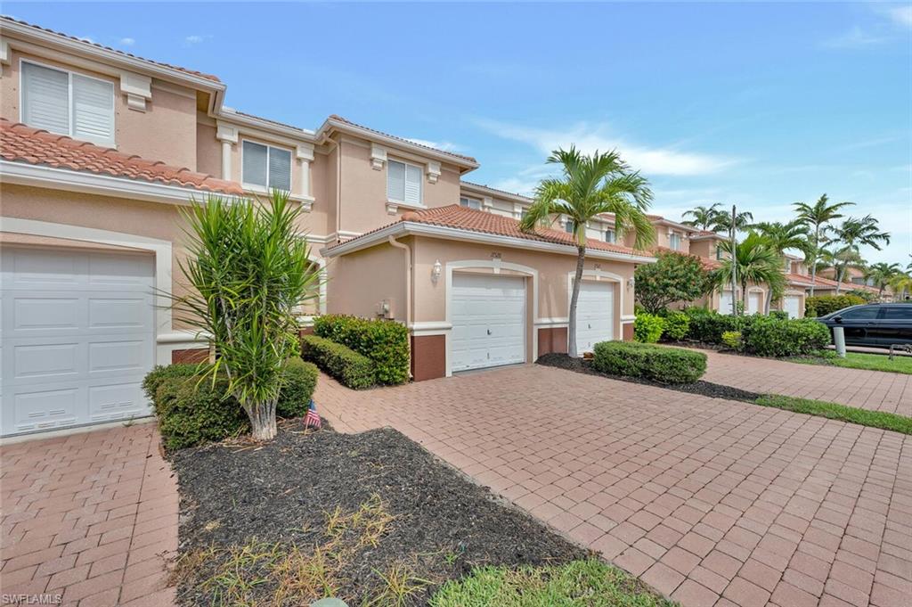 17528 Cherry Ridge Lane Fort Myers, FL 33967 - Photo 1 of 18 a front view of a house with a yard and a garage