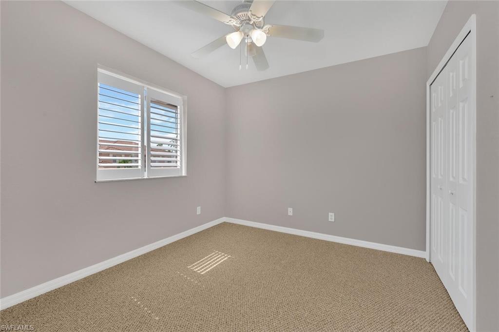 17528 Cherry Ridge Lane Fort Myers, FL 33967 - Photo 14 of 18 an empty room with a window and a fan