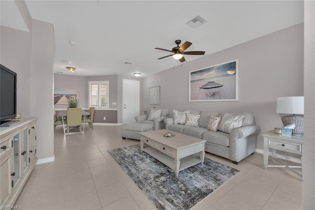 17528 Cherry Ridge Lane Fort Myers, FL 33967 - Photo 2 of 18 a living room with furniture and a flat screen tv