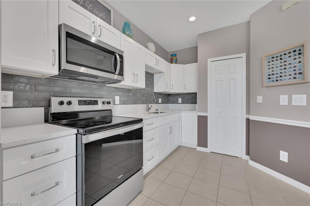 17528 Cherry Ridge Lane Fort Myers, FL 33967 - Photo 5 of 18 a kitchen with cabinets stainless steel appliances and sink