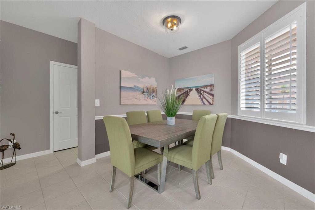 17528 Cherry Ridge Lane Fort Myers, FL 33967 - Photo 7 of 18 a view of a dining room with furniture and a large window