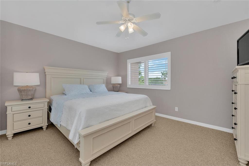 17528 Cherry Ridge Lane Fort Myers, FL 33967 - Photo 9 of 18 a bedroom with a bed and a chandelier