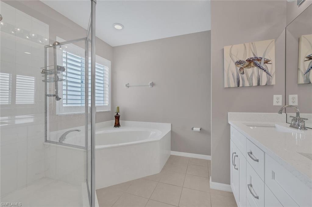 17528 Cherry Ridge Lane Fort Myers, FL 33967 - Photo 10 of 18 a bathroom with a bathtub and a sink