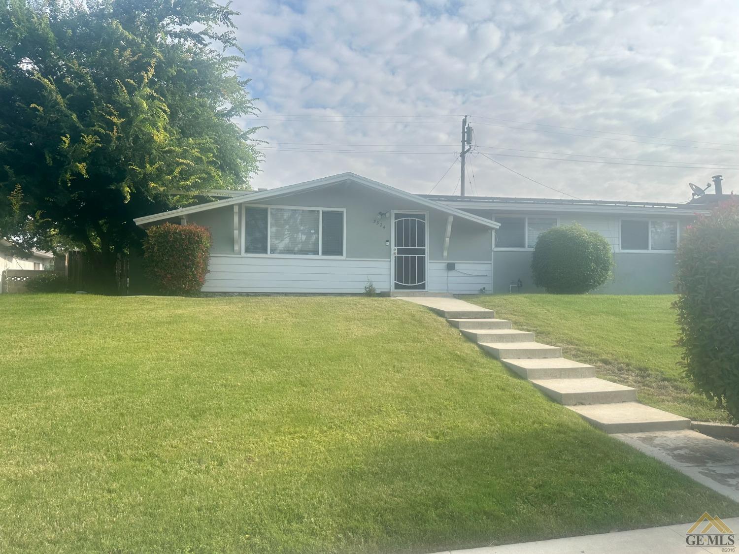 Undisclosed Address Bakersfield, CA 93306 - Photo 4 of 4 a view of a yard in front of a house with a small yard