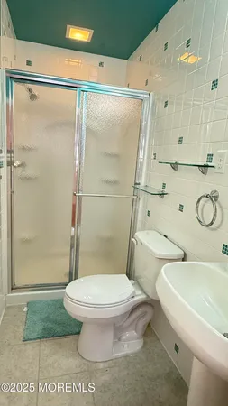 a white toilet sitting next to a bathroom sink