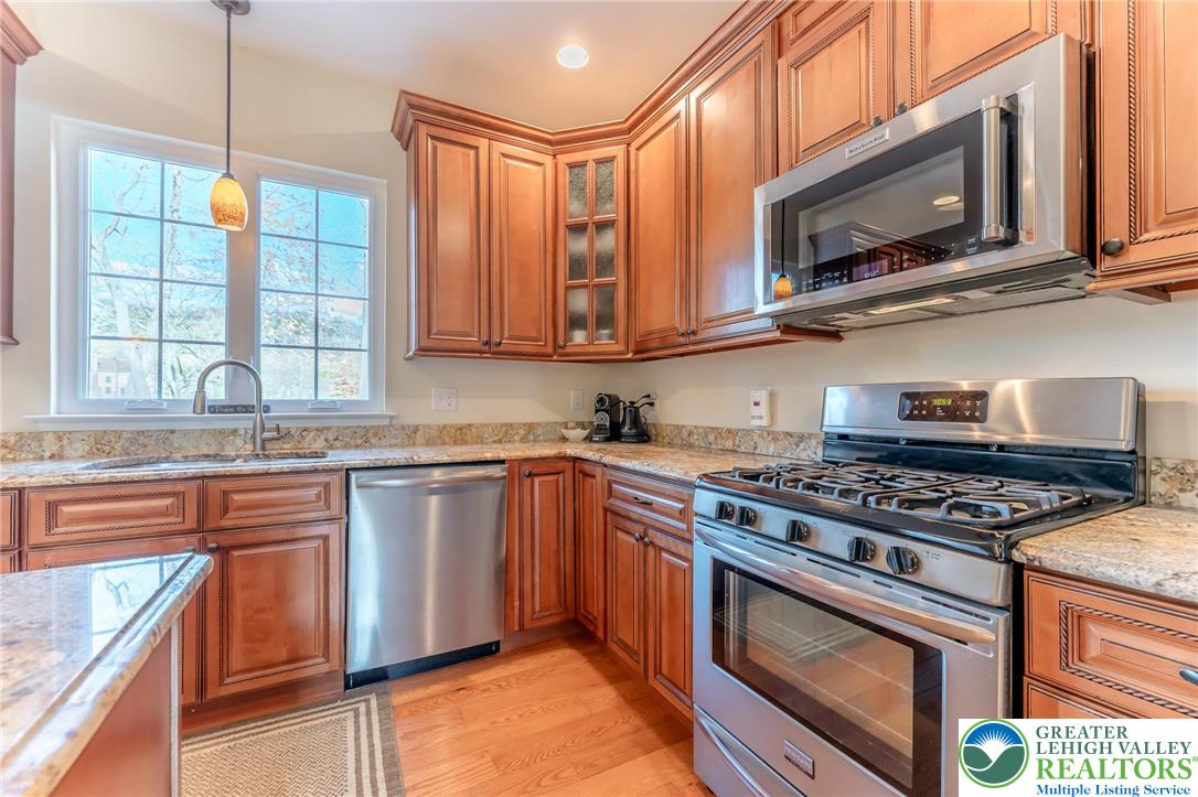 3505 Woodbyne Road Hellertown, PA 18055 - Photo 12 of 66 a kitchen with granite countertop a stove top oven microwave and cabinets