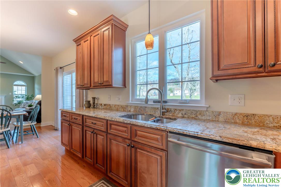 3505 Woodbyne Road Hellertown, PA 18055 - Photo 13 of 66 a kitchen with stainless steel appliances granite countertop wooden cabinets a sink and dishwasher a stove with wooden floors