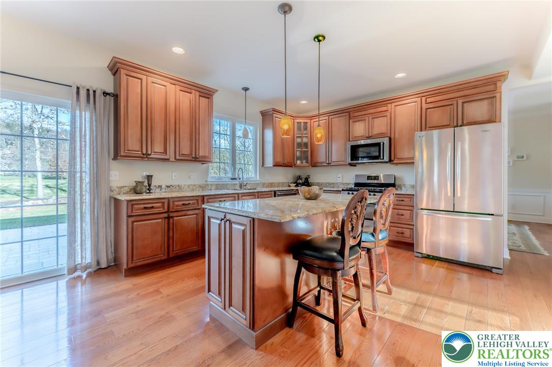 3505 Woodbyne Road Hellertown, PA 18055 - Photo 14 of 66 a kitchen with stainless steel appliances a stove a refrigerator a sink a stove a dining table and chairs