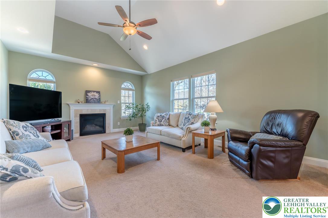 3505 Woodbyne Road Hellertown, PA 18055 - Photo 17 of 66 a living room with furniture a fireplace and a flat screen tv