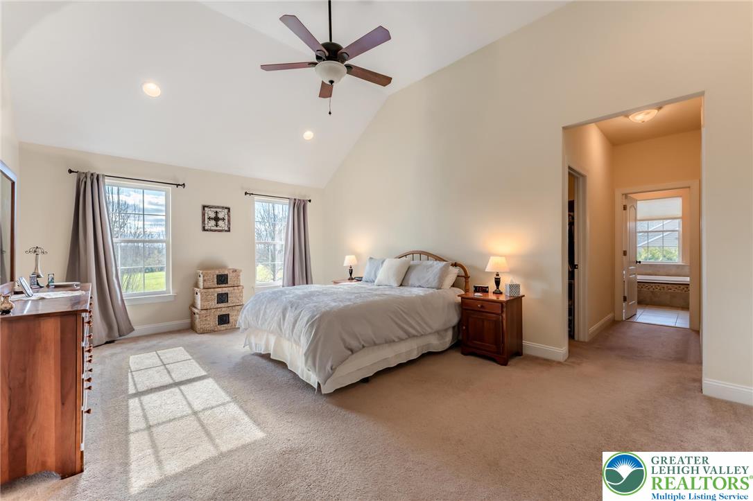 3505 Woodbyne Road Hellertown, PA 18055 - Photo 28 of 66 a spacious bedroom with a bed and a chandelier