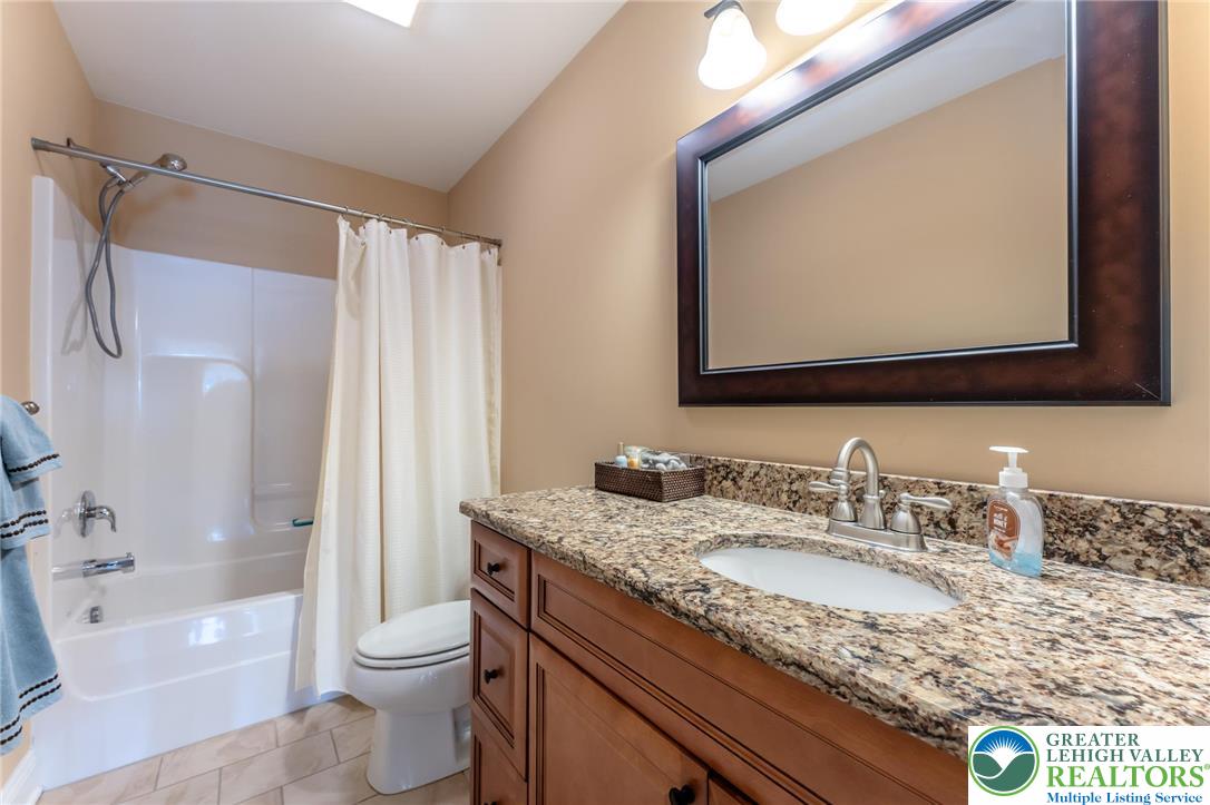 3505 Woodbyne Road Hellertown, PA 18055 - Photo 37 of 66 a bathroom with a granite countertop sink mirror vanity and toilet