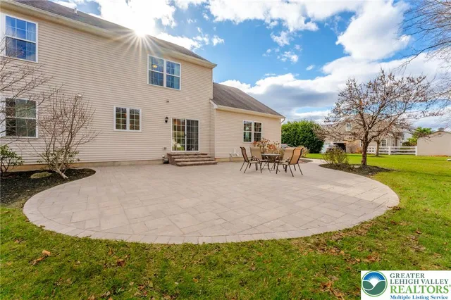 an aerial view of a house with pool yard and outdoor seating