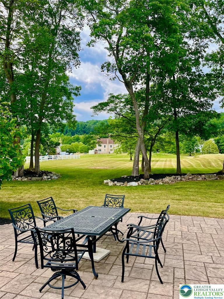 3505 Woodbyne Road Hellertown, PA 18055 - Photo 58 of 66 an outdoor view of a house with garden and outdoor seating