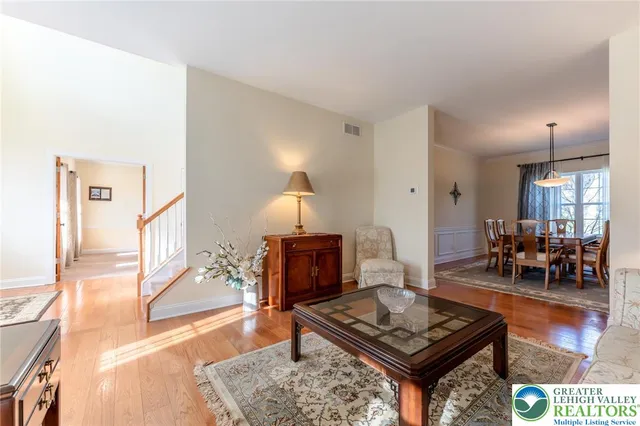 a dining room with furniture window and wooden floor