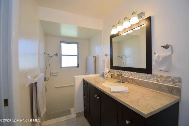 a bathroom with a sink vanity and a mirror