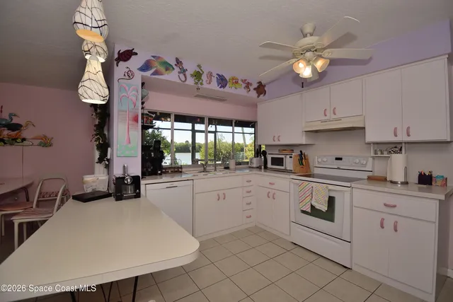 a kitchen with cabinets a sink and appliances