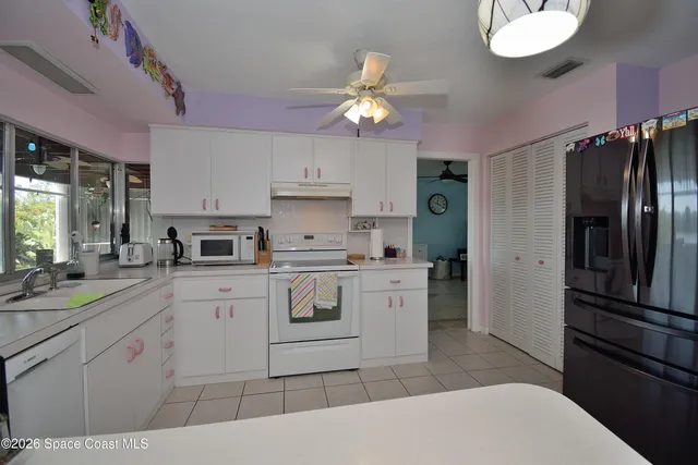 a kitchen with a sink stainless steel appliances and cabinets
