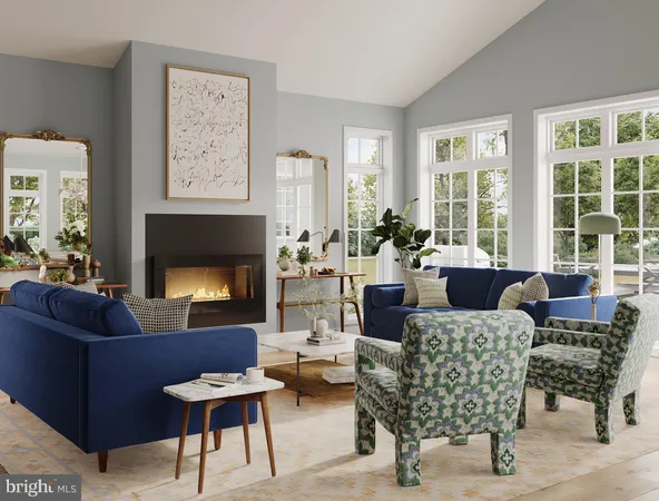 a living room with furniture fireplace and a large window
