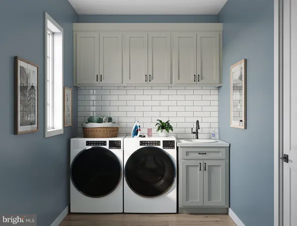 a utility room with sink dryer and washer