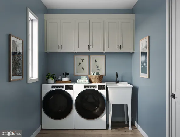 a utility room with sink dryer and washer