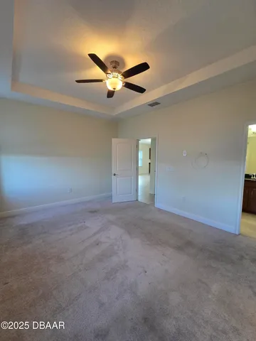 a view of a livingroom with a ceiling fan and window