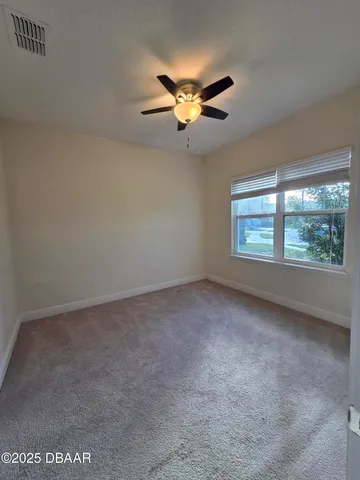 a view of a livingroom with a ceiling fan and window