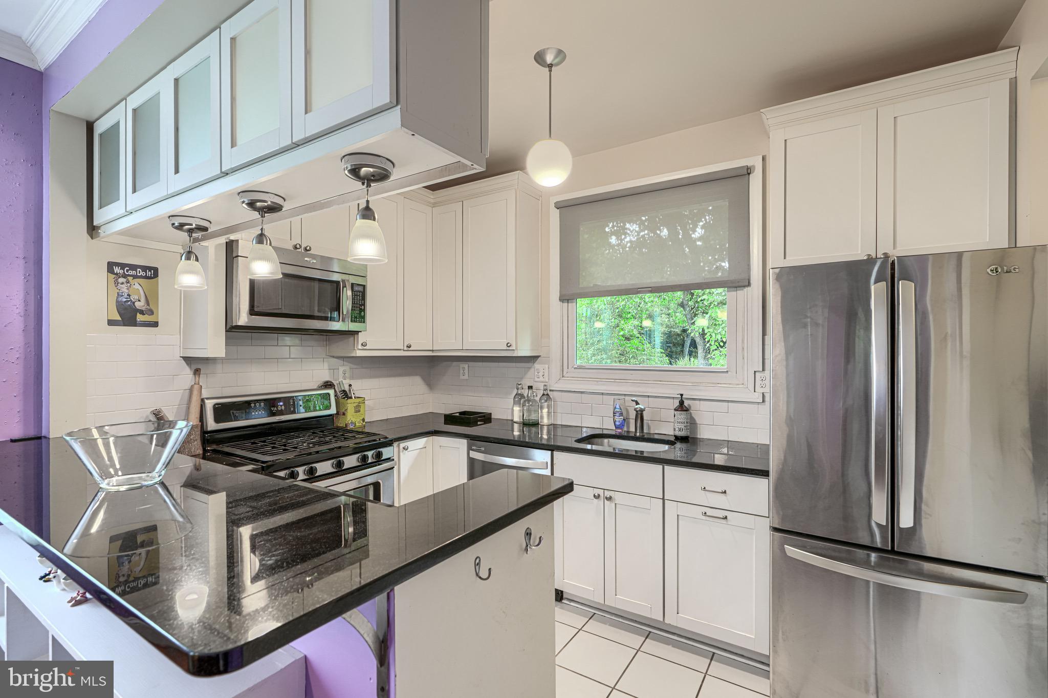 2705 Latona Road Baltimore, MD 21214 - Photo 15 of 53 a kitchen with stainless steel appliances granite countertop a sink a stove a refrigerator and cabinets