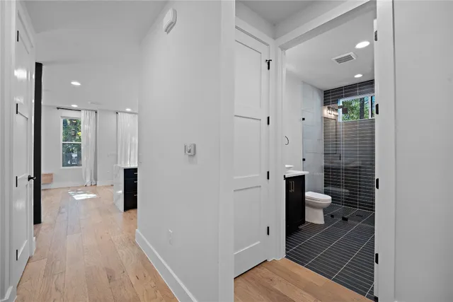 a view of an empty room with wooden floor