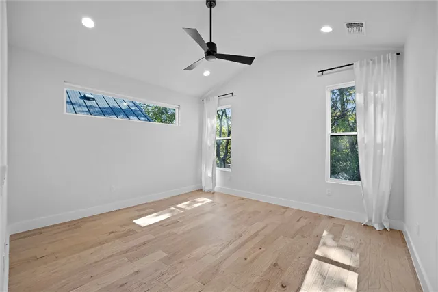 a view of empty room with wooden floor