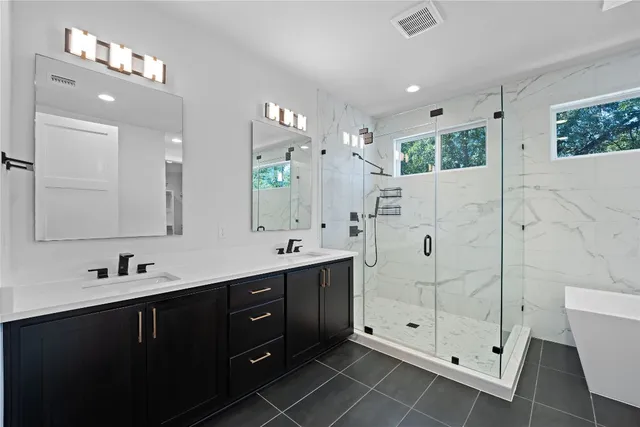 a bathroom with a bathtub and a shower