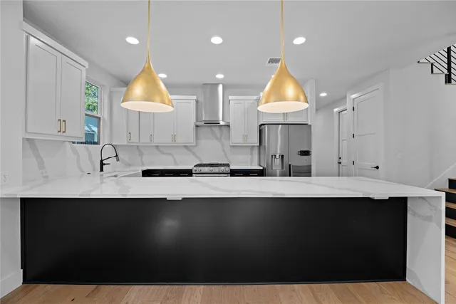a kitchen with kitchen island granite countertop a sink window and cabinets