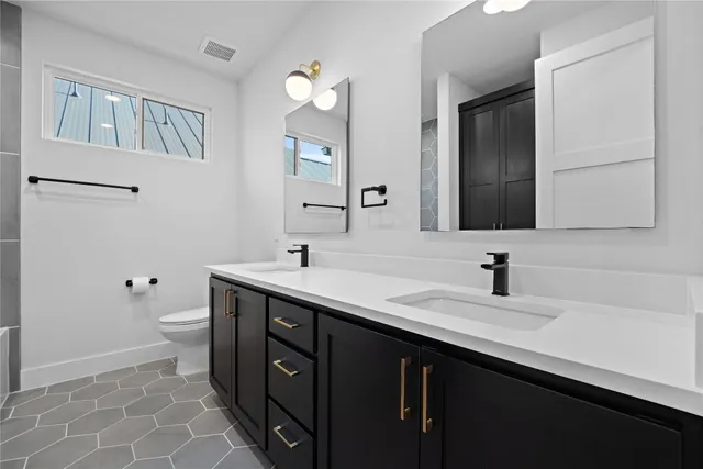 a view of a livingroom with wooden floor and a ceiling fan