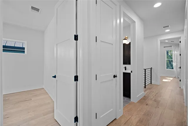 an empty room with fireplace and windows