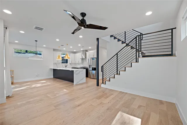 a view of kitchen and hall with wooden floor