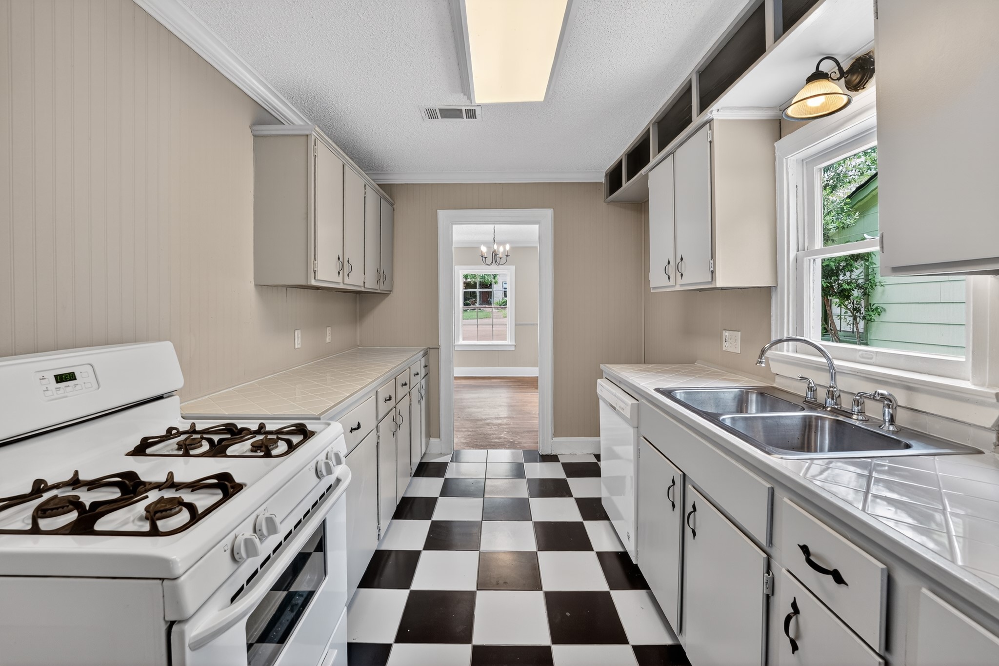 4907 Duval Street Austin, TX 78751 - Photo 10 of 31 a kitchen with a sink a stove and a refrigerator