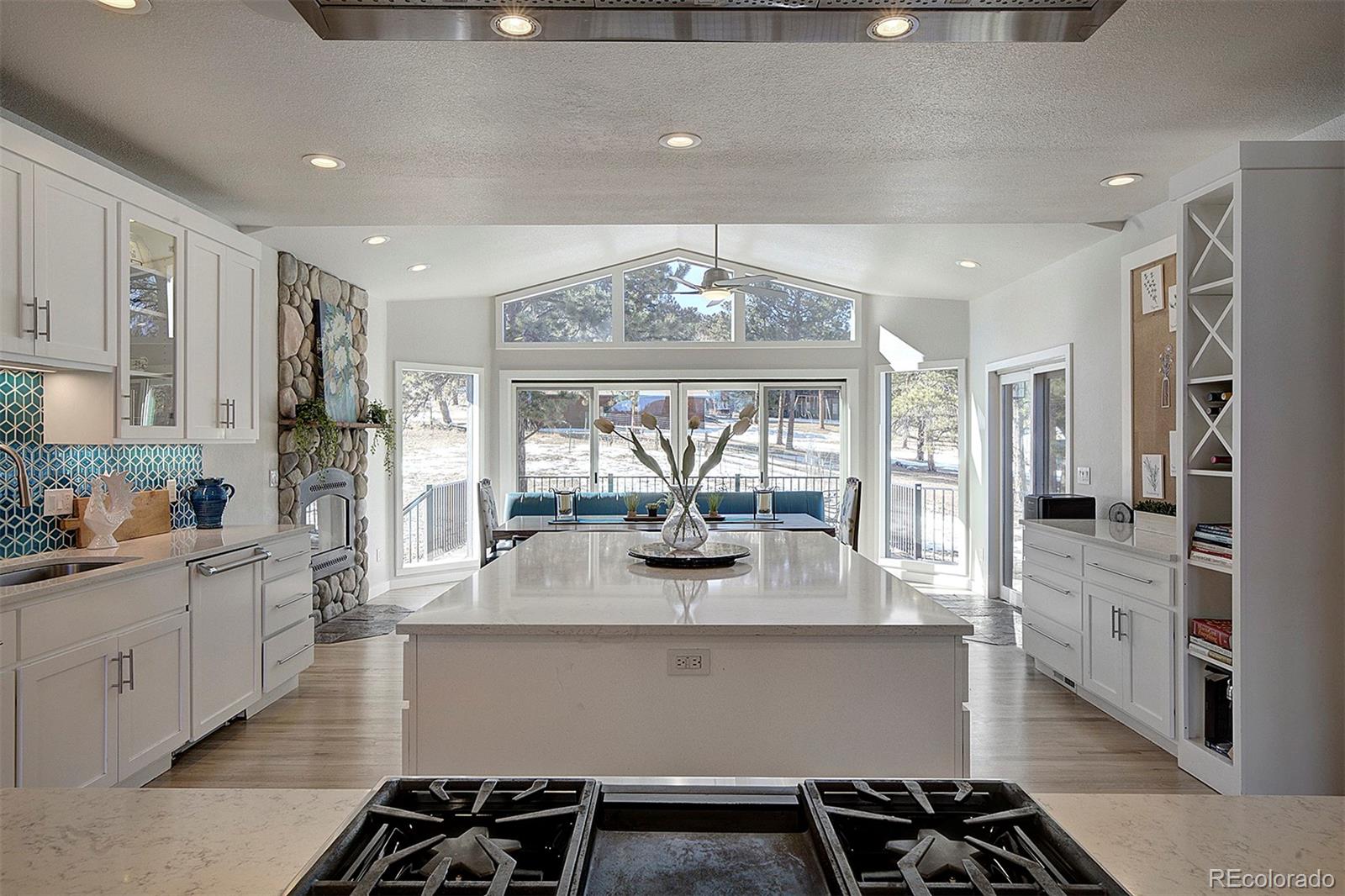 a kitchen with stainless steel appliances granite countertop a sink and a stove