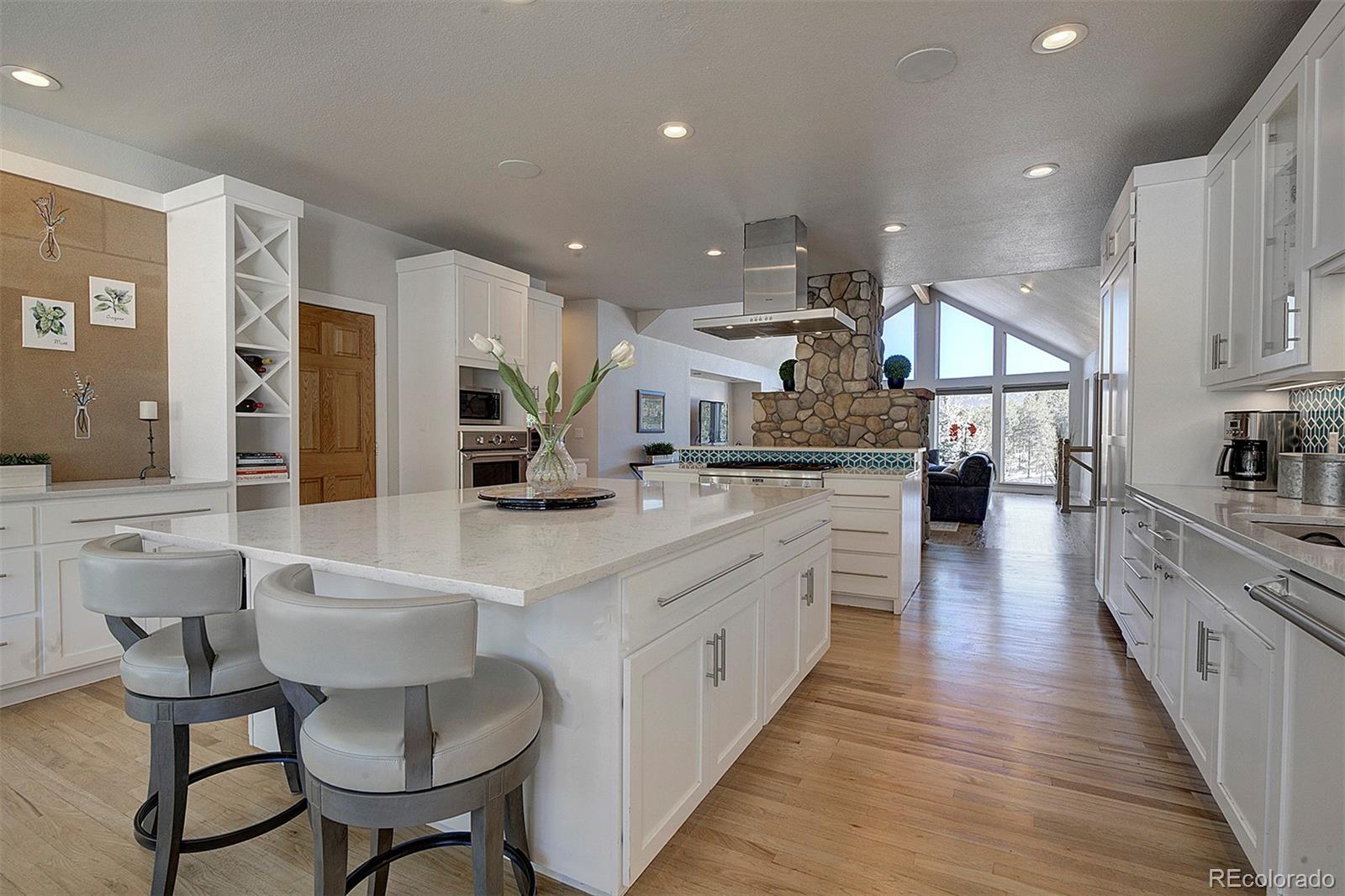 5371 Hazel Road Evergreen, CO 80439 - Photo 12 of 47 a large kitchen with stainless steel appliances lots of counter space and breakfast area