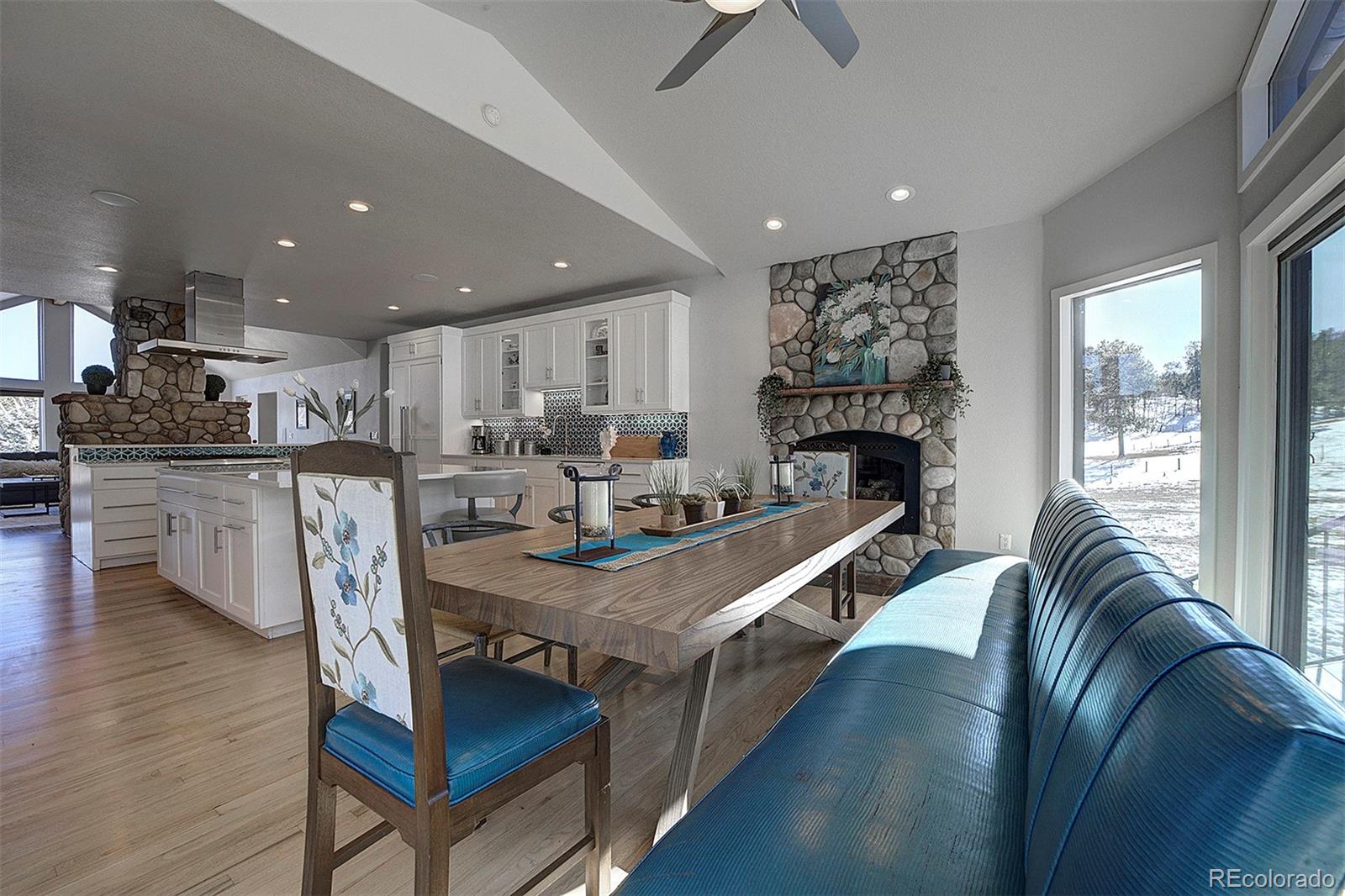 5371 Hazel Road Evergreen, CO 80439 - Photo 15 of 47 a living room with stainless steel appliances furniture a rug and a kitchen view