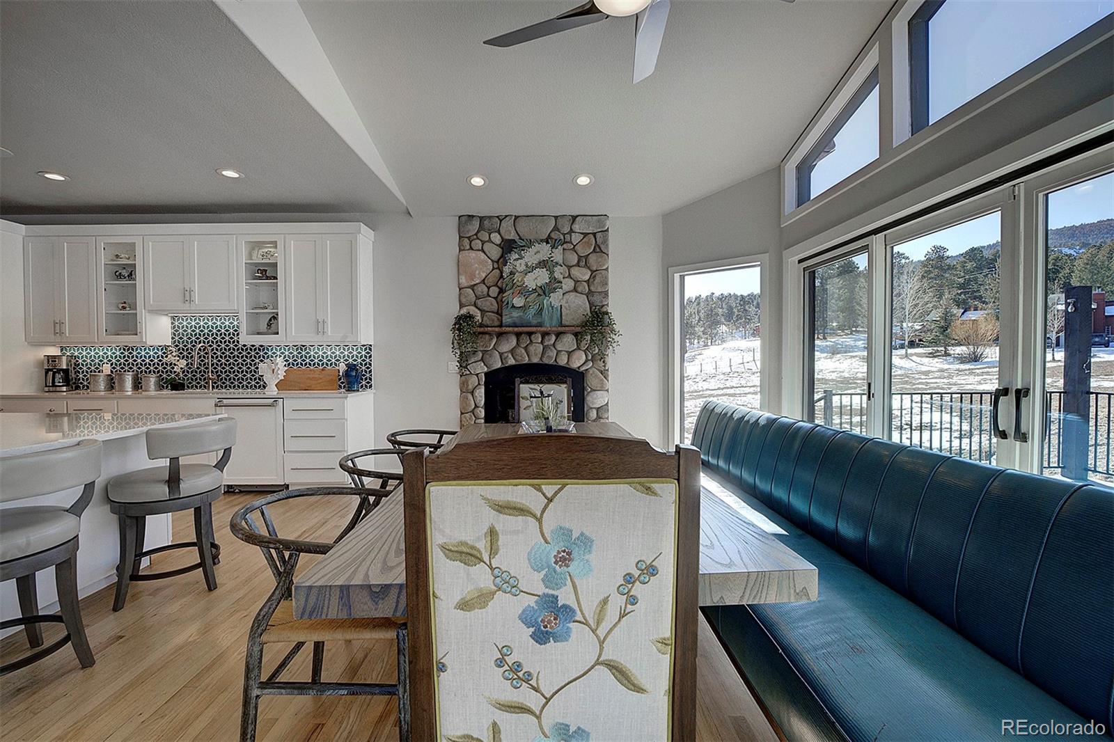 5371 Hazel Road Evergreen, CO 80439 - Photo 16 of 47 a living room with furniture and a fireplace