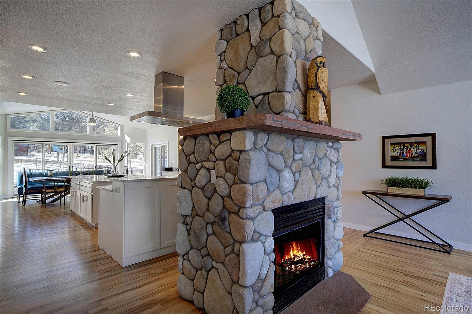 5371 Hazel Road Evergreen, CO 80439 - Photo 17 of 47 a living room with furniture and a fireplace