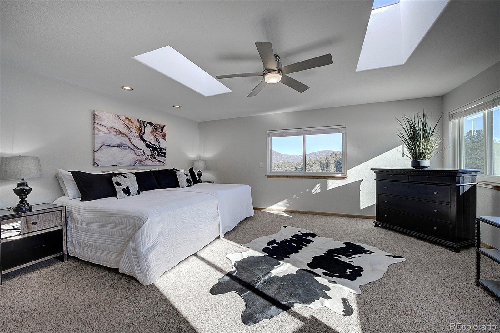 5371 Hazel Road Evergreen, CO 80439 - Photo 29 of 47 a bedroom with a bed and a dresser