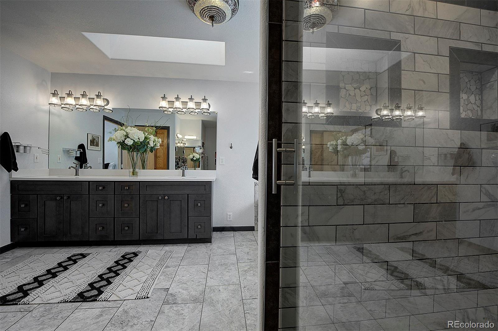 5371 Hazel Road Evergreen, CO 80439 - Photo 34 of 47 a bathroom with a sink and a mirror