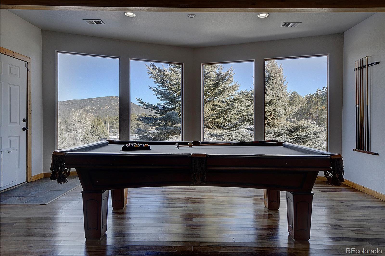 5371 Hazel Road Evergreen, CO 80439 - Photo 36 of 47 a room with wooden floor and a large window