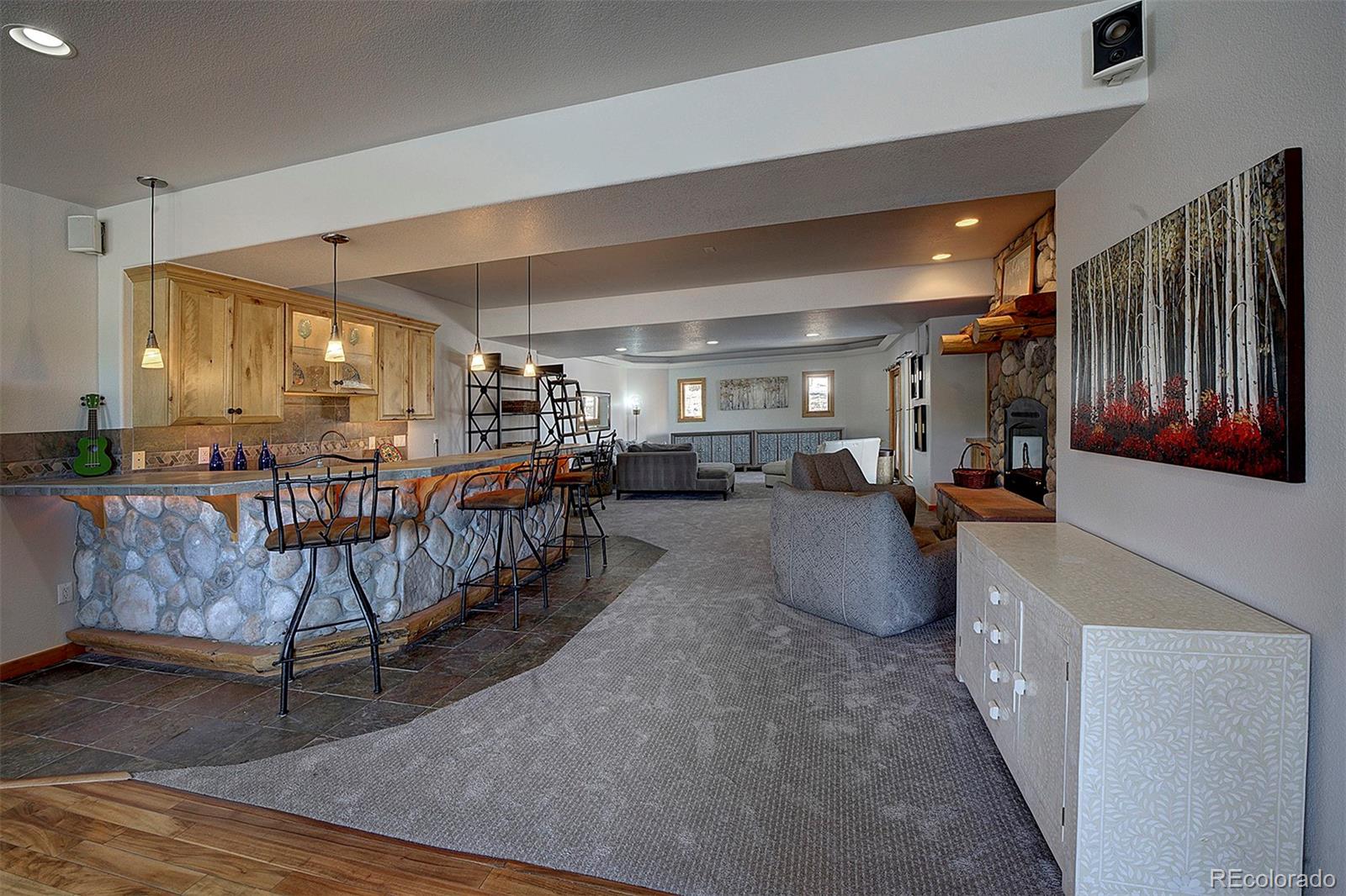 5371 Hazel Road Evergreen, CO 80439 - Photo 38 of 47 a living room with furniture and a chandelier