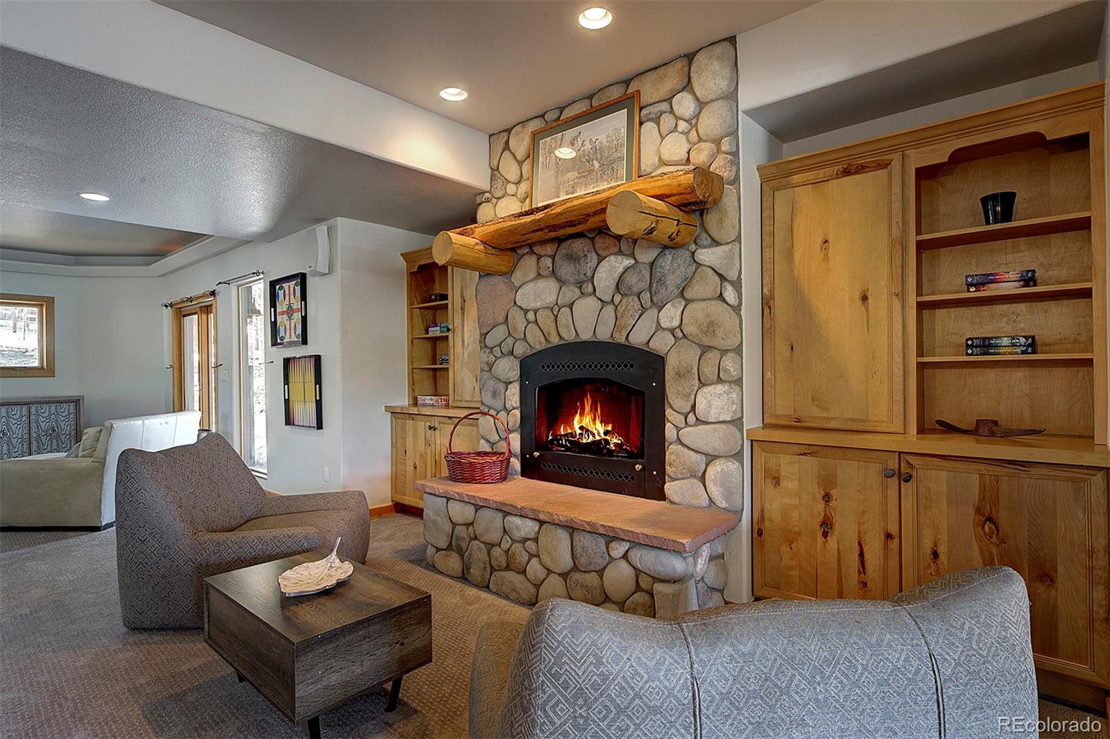 5371 Hazel Road Evergreen, CO 80439 - Photo 43 of 47 a living room with furniture and a fireplace