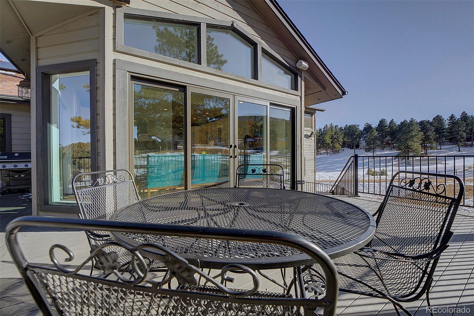5371 Hazel Road Evergreen, CO 80439 - Photo 47 of 47 a view of a patio with couches table and chairs