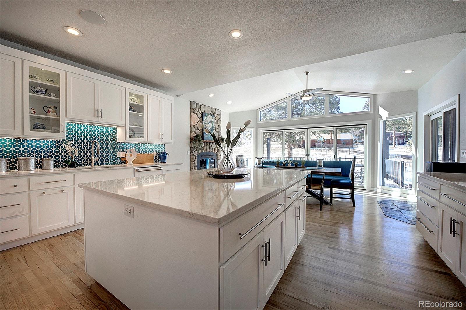 5371 Hazel Road Evergreen, CO 80439 - Photo 10 of 47 a kitchen with counter top space and wooden floor
